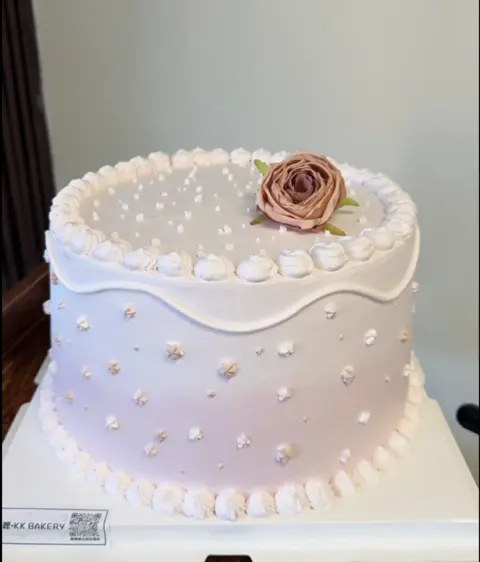 #414 elegant white cake with single blush rose, pearl border and delicate piping by KK Bakery in Rosemead