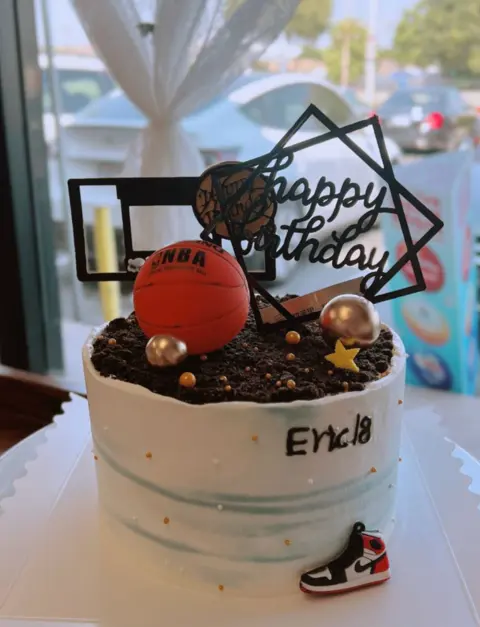 #416 basketball birthday cake with ball topper, chocolate crumbs and sports decorations by KK Bakery in Rosemead