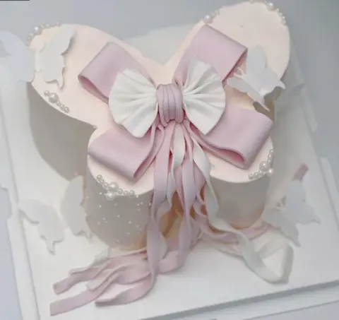 #417 white gift box cake with large pink bow, ribbon tails and pearl details by KK Bakery in Rosemead