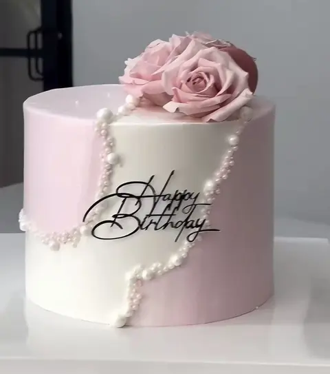 #425 pink and white birthday cake with large rose, pearl strands and elegant lettering by KK Bakery in Rosemead