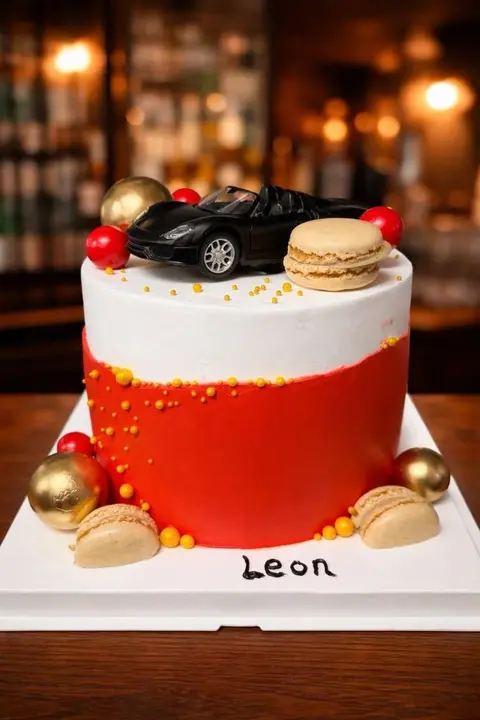 #432 red and white birthday cake with luxury car topper, macarons and gold spheres by KK Bakery in Rosemead