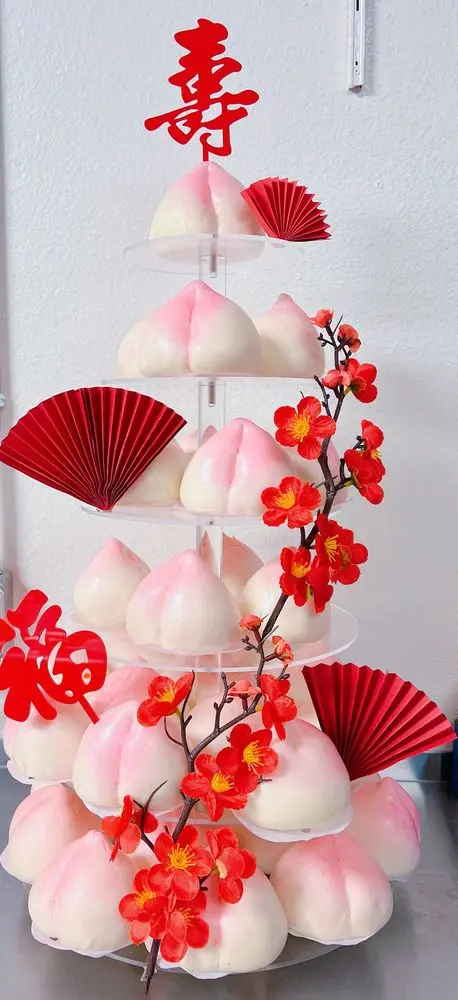 #501 Chinese longevity peach bun tower with red fans, blossoms and blessing decorations by KK Bakery in Rosemead