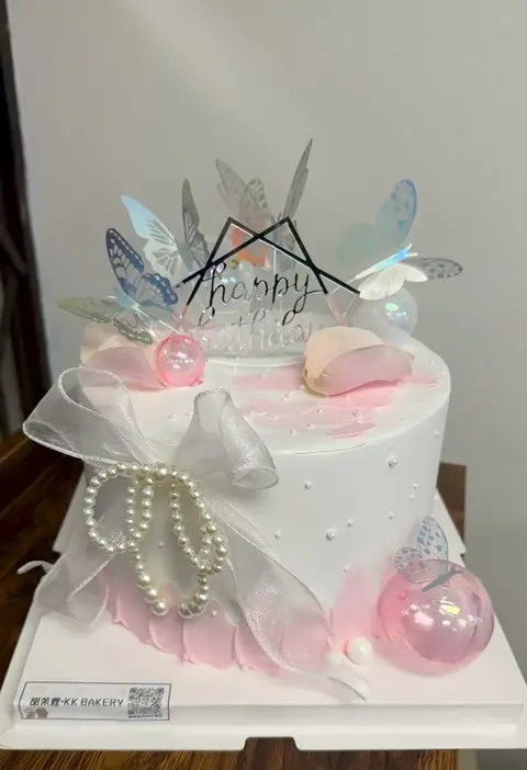 #507 white and pink birthday cake with butterfly toppers, bows and pearl decorations by KK Bakery in Rosemead