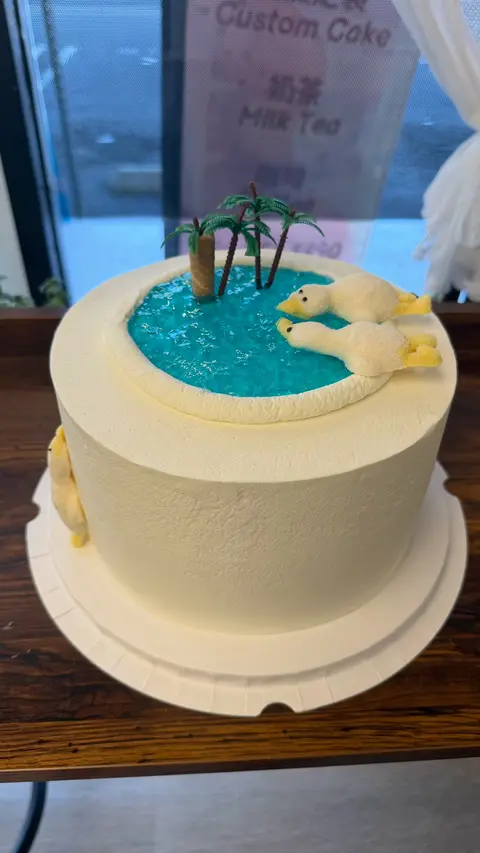 #526 pool themed birthday cake with blue water, lounge figure and palm tree by KK Bakery in Rosemead
