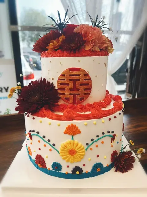 #534 two tier Chinese wedding cake with red double happiness symbol and fresh flowers by KK Bakery in Rosemead