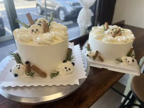#537 cream birthday cake with cute bear figures, bows and paw print decorations by KK Bakery in Rosemead