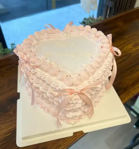 #541 pink vintage heart shaped cake with layered ruffles, bows and piped borders by KK Bakery in Rosemead