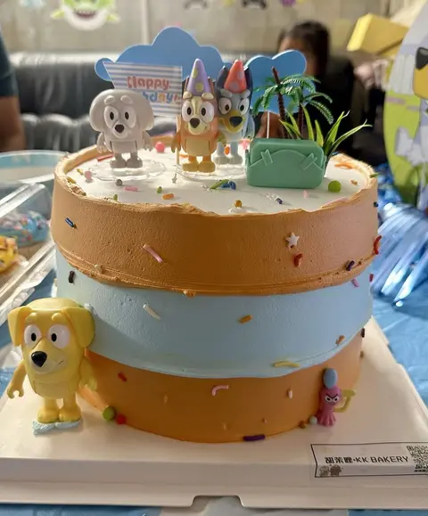 #564 Bluey inspired two tier birthday cake with character toppers and beach theme by KK Bakery in Rosemead