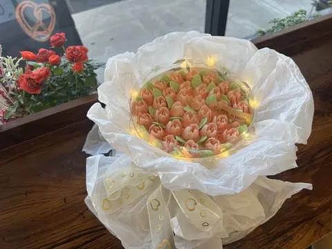 #567 pink flower bouquet cake wrapped in white ruffles with ribbon details by KK Bakery in Rosemead