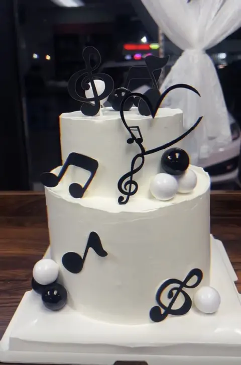#570 black and white music themed cake with notes and round decorations by KK Bakery in Rosemead
