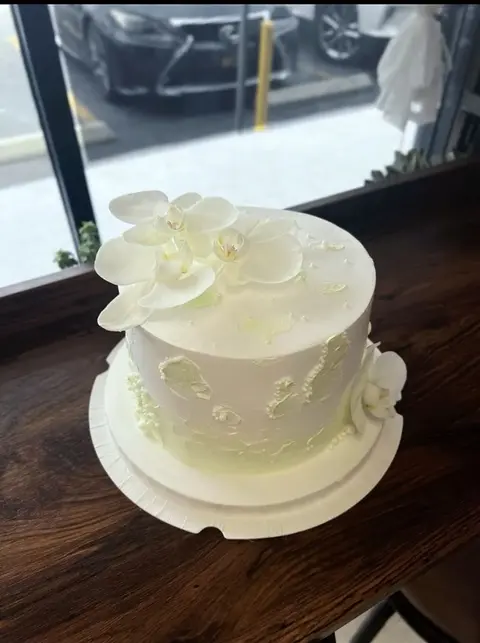#571 elegant white cake with large white orchid and pearl decorations by KK Bakery in Rosemead