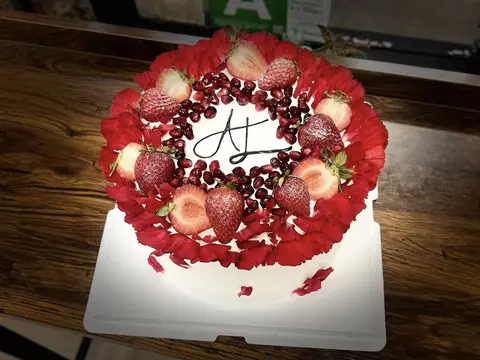 #583 chocolate cake topped with fresh strawberries, berries and red chocolate decorations by KK Bakery in Rosemead