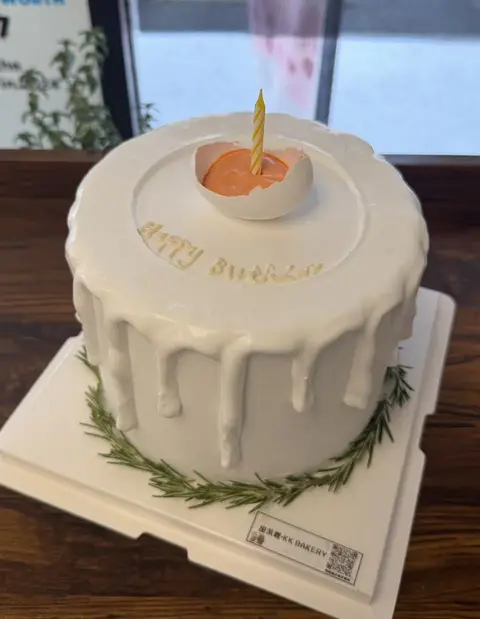 #586 minimalist white drip cake with delicate greenery and simple topper by KK Bakery in Rosemead