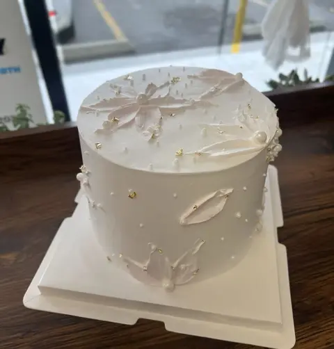 #591 minimalist gray cake with silver butterfly and pearl decorations by KK Bakery in Rosemead