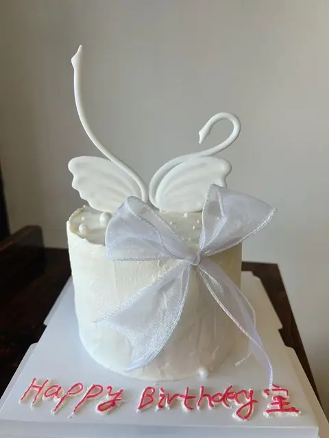#594 elegant white birthday cake with angel wings and sheer bow by KK Bakery in Rosemead