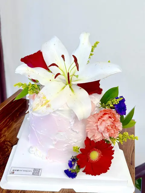 #612 floral cake with white lilies, red roses and colorful fresh flowers by KK Bakery in Rosemead