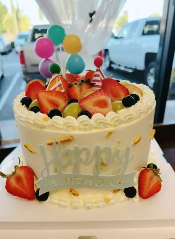 #621 fresh fruit birthday cake with strawberries, grapes, blueberries and colorful balloon toppers by KK Bakery in Rosemead