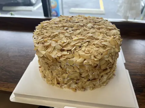 #634 round cake covered with toasted sliced almonds by KK Bakery in Rosemead