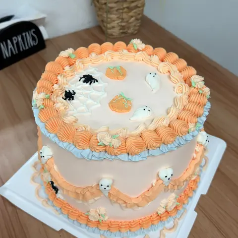 #637 pastel orange Halloween cake with ghosts, pumpkins, spiders and a piped spiderweb by KK Bakery in Rosemead