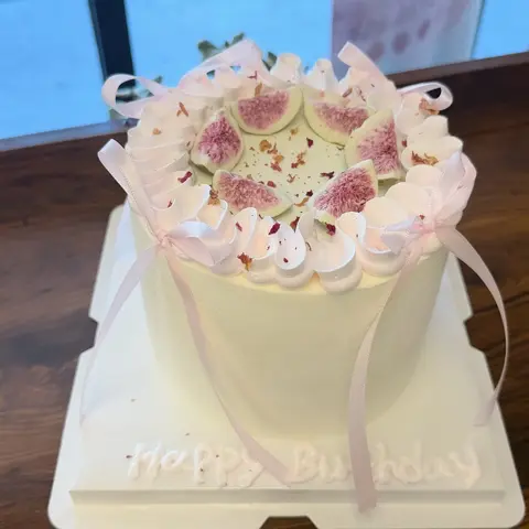 #638 elegant birthday cake with fresh figs, white buttercream swirls and pale pink ribbon bows by KK Bakery in Rosemead
