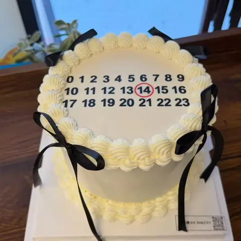 #641 white birthday cake with calendar number design, circled date and black ribbon bows by KK Bakery in Rosemead