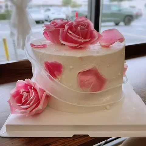 #645 elegant white cake with fresh pink roses, scattered rose petals and sheer ribbon by KK Bakery in Rosemead